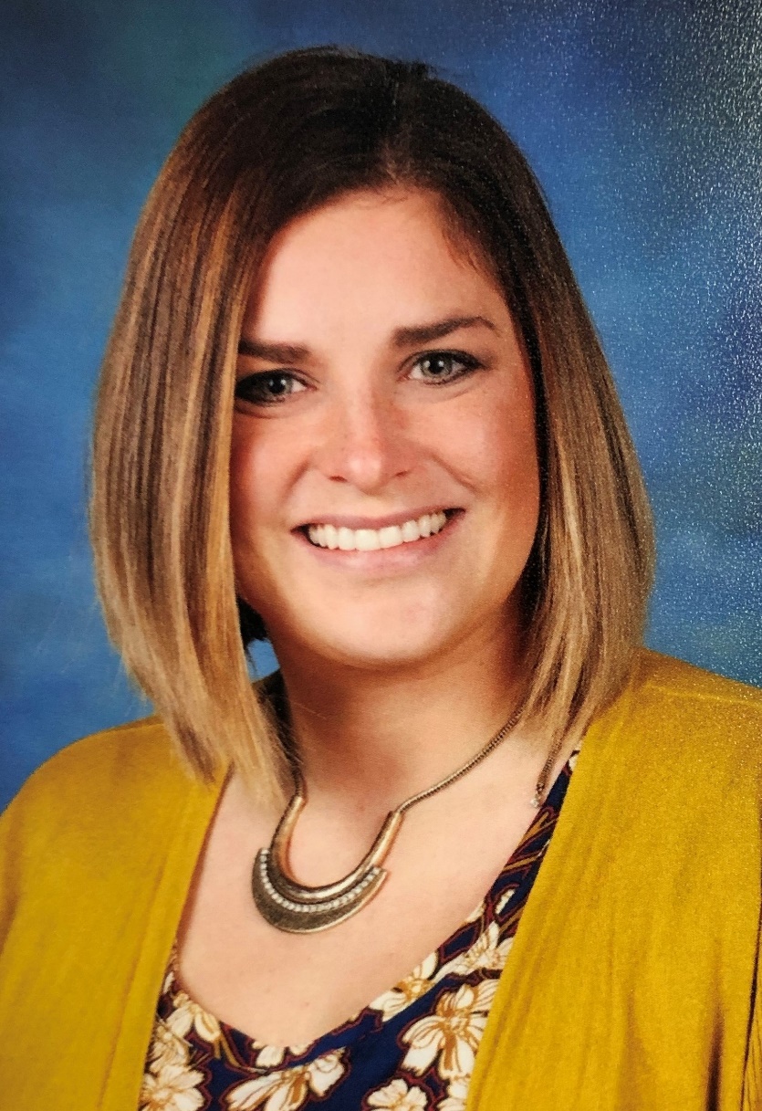 A person smiling for a pictureDescription automatically generated